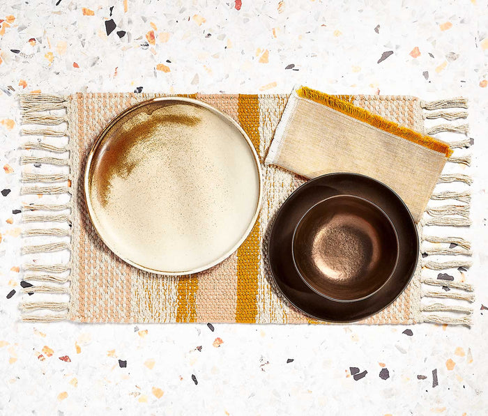 Boho ochre, blush, and cream striped woven fringe placemats set.  With dinnerware and fringe woven napkins.
