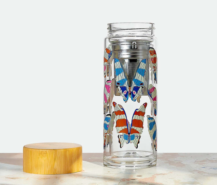 Clear glass tea infuser with butterfly designs on a white background - Lollygag