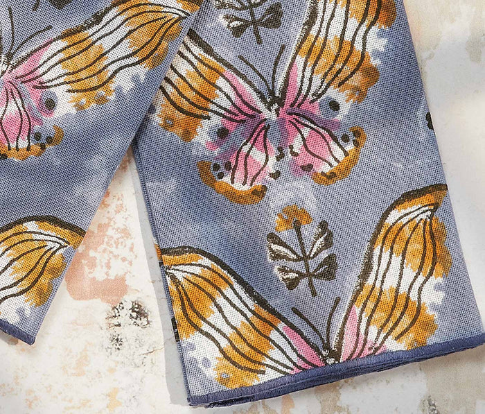 Butterfly-patterned towels on a marble surface