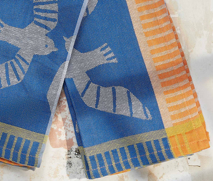 Colorful fabric with birds patterns on a textured surface