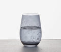 stemless smoky wine glasses on concrete slab  - Lollygag