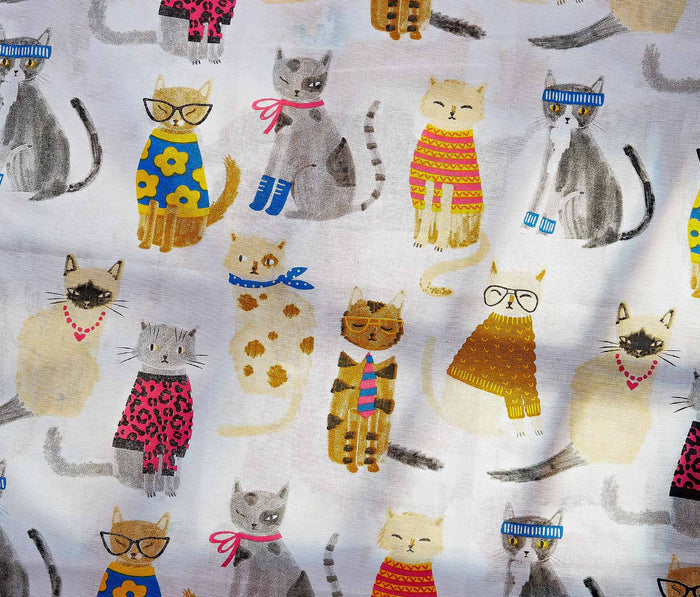 Two kitchen towels with cat illustrations on a textured surface - Lollygag