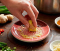 Grating ginter in a small pink grate plate - Lollygag