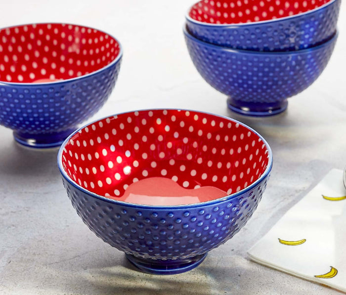 Set of blue and red polka dot bowls on a light surface - Lollygag