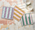 Three square woven cotton potholders in striped pink, mint green, plum, and ochre yellow, displayed together as a kitchen gift set. - Lollygag