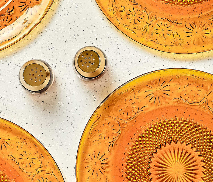 Top view Decorative orange plates with embossed flower pattern - lollygag